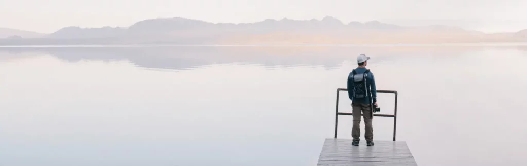man with a camera on a dock