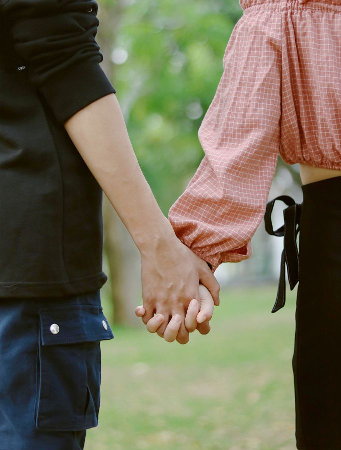 young adult couple holding hands