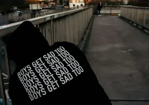 Sad Boy with Hoodie that says "Boys Get Sad Too"
