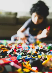 Boy plays with Lego